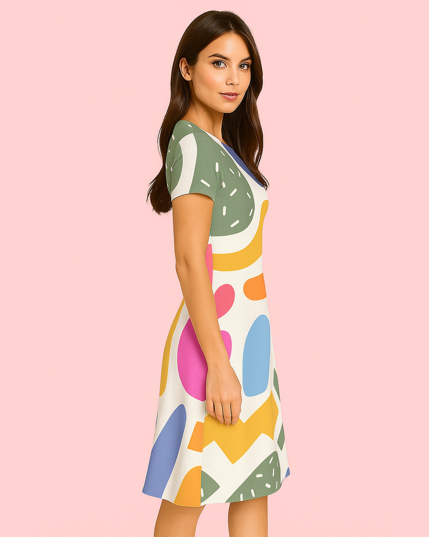 Woman wearing a colorful dress with abstract patterns on a pink background