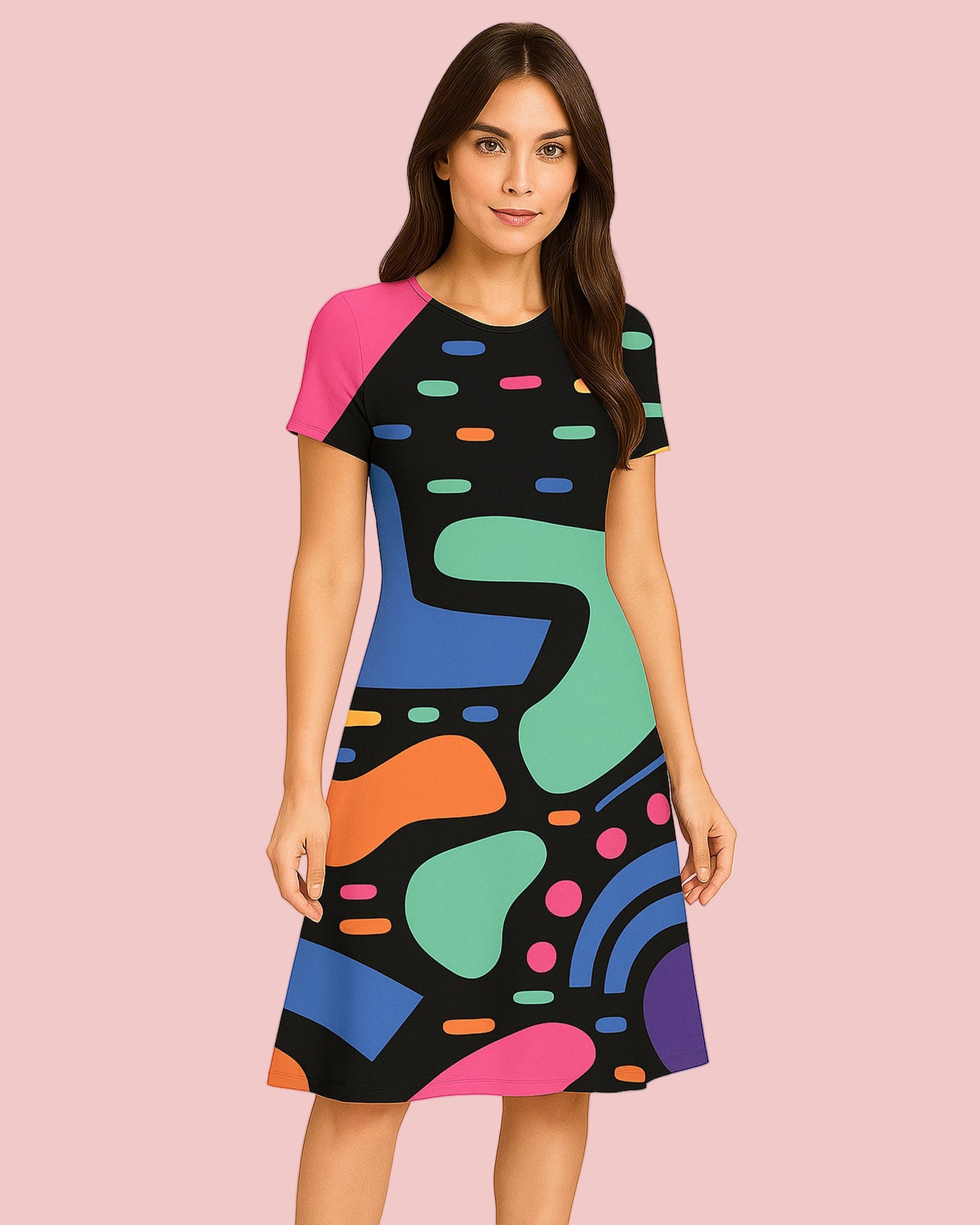 Woman wearing a colorful dress with abstract patterns on a pink background
