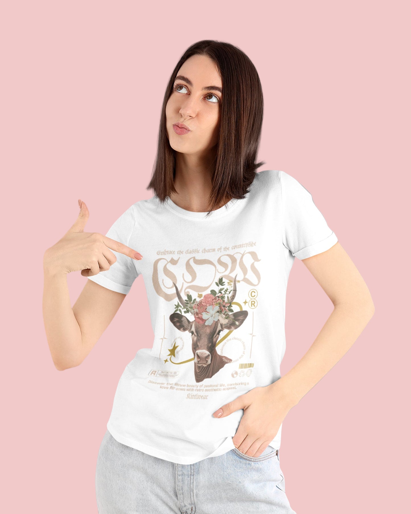 Woman pointing to a white t-shirt with a graphic design on a gray background