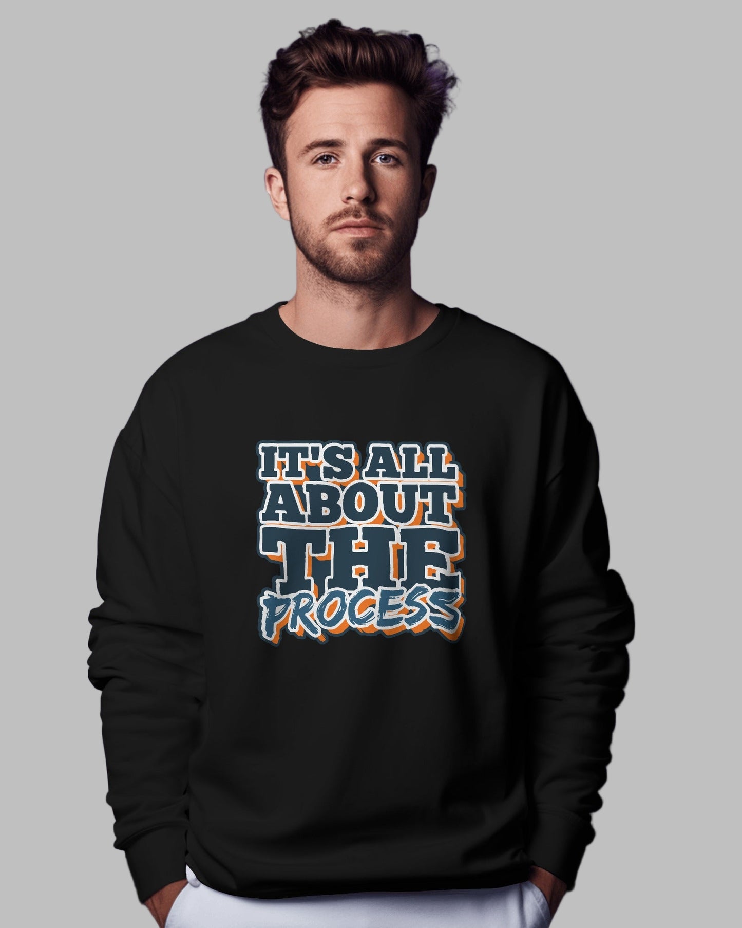 Man wearing a black sweatshirt with 'It's All About The Process' text against a purple background