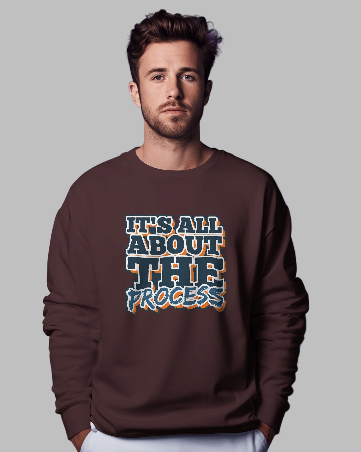 Man wearing a brown sweatshirt with text on a purple background