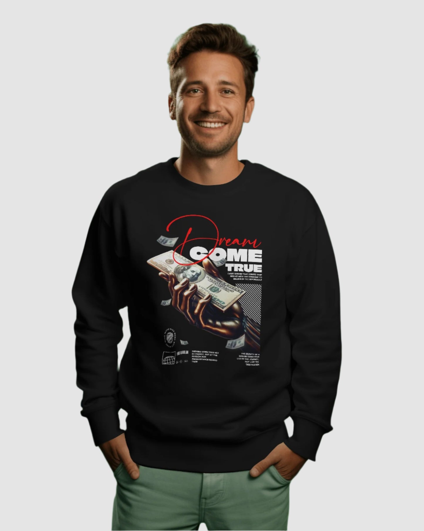 Man wearing a black sweatshirt with graphic design on a green background