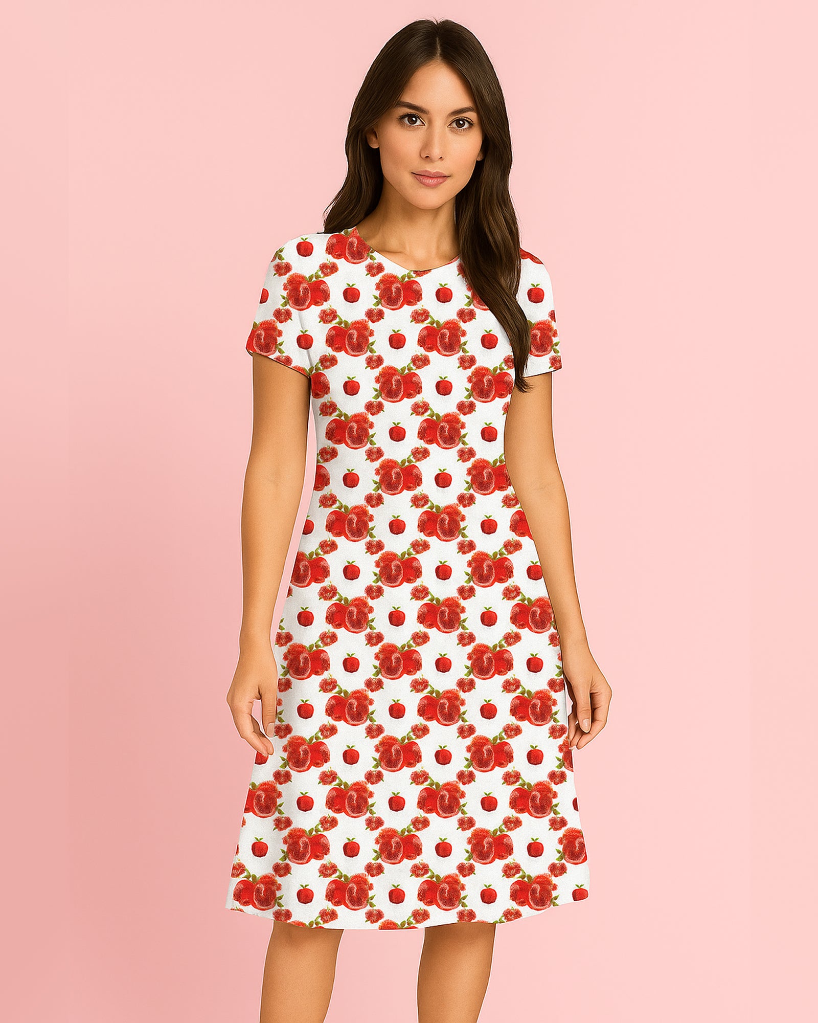 Woman wearing a white dress with red floral pattern on a pink background