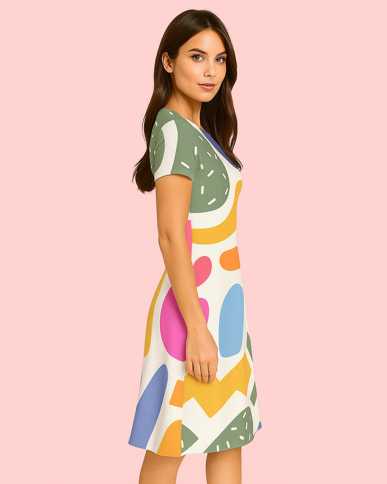 Woman wearing a colorful dress with abstract patterns on a pink background