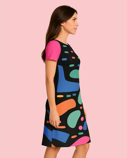 Woman wearing a colorful dress with abstract patterns on a pink background