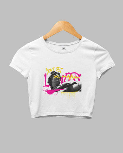 White crop top with graphic design on a hanger against a dark background