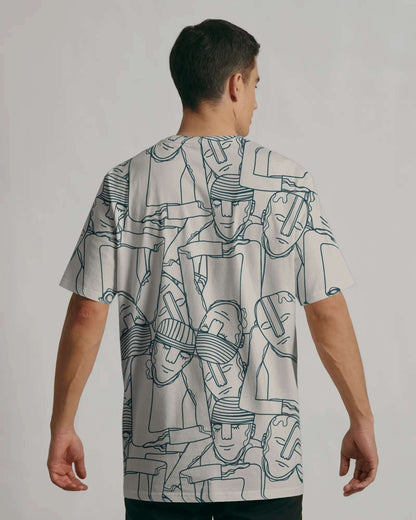 Person wearing a notch white t-shirt with black abstract patterns on a plain background
