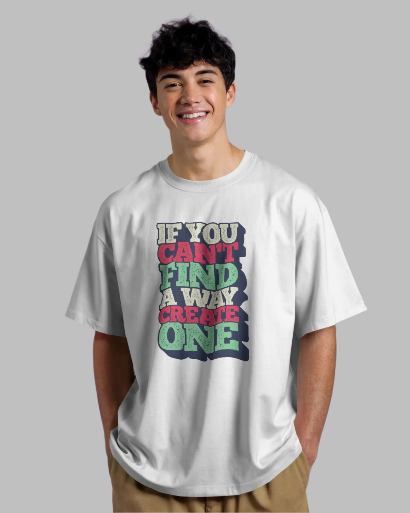 Person wearing a white t-shirt with colorful text on a purple background